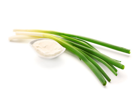 Gravy boat of tasty sour cream with green onion on white backgroundの写真素材
