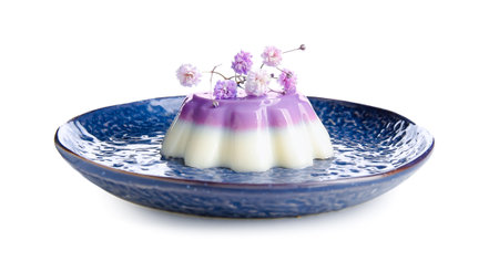 Plate of panna cotta with beautiful gypsophila flowers on white backgroundの写真素材