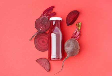 Bottle of healthy beet juice on red backgroundの写真素材