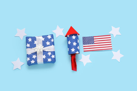 Gift box with firework rocket, USA flag and stars on blue background. american independence dayの写真素材