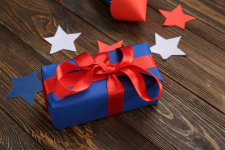 Gift box and stars on brown wooden background. american independence dayの写真素材