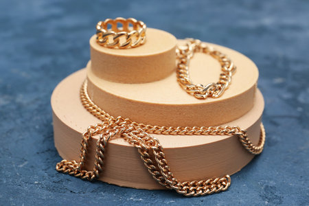 Decorative podiums with beautiful jewelery on blue backgroundの写真素材