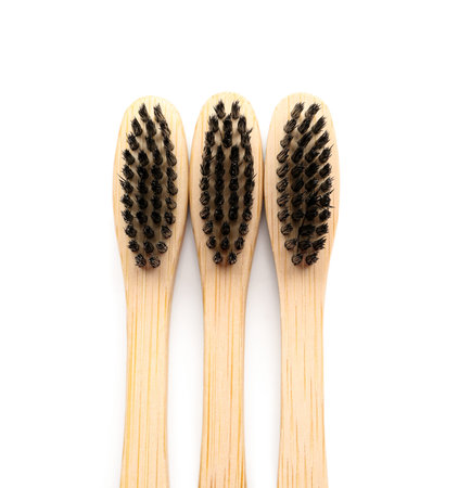 Bamboo toothbrushes on white background