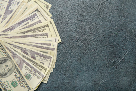 One hundred dollar banknotes on black grunge background