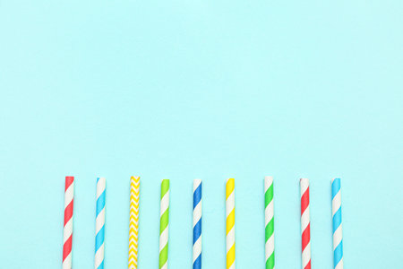 Different paper drinking straws on blue backgroundの写真素材