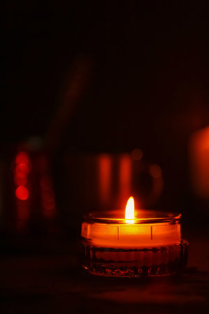Beautiful burning candles on black backgroundの写真素材