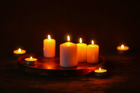 Beautiful burning candles on black backgroundの写真素材