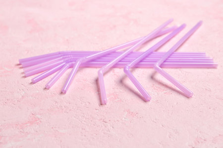 Many purple straws on grunge pink backgroundの写真素材
