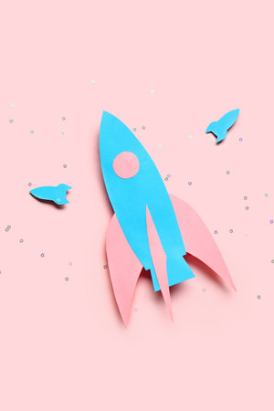 Blue paper rockets on pink background