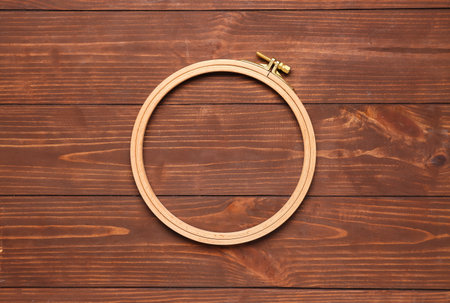 Embroidery hoops on brown wooden backgroundの写真素材