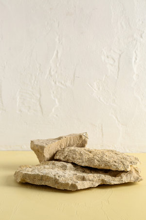 Decorative stone podiums on yellow table