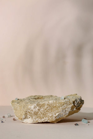 Decorative stone podium on beige background