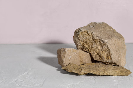 Decorative stone podiums on white textured table