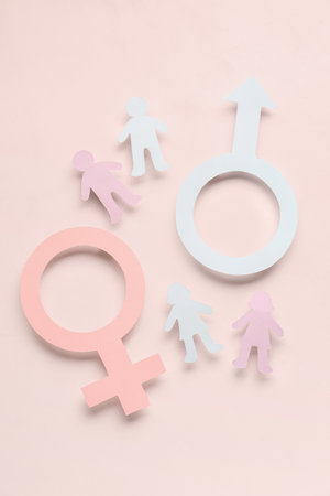 Gender symbols of woman and man with figures on pale pink backgroundの写真素材