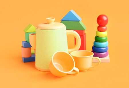 Different colorful toys on orange background. Children's Day celebration