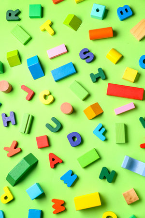 Wooden letters with colorful blocks on green background. Children's Day celebration