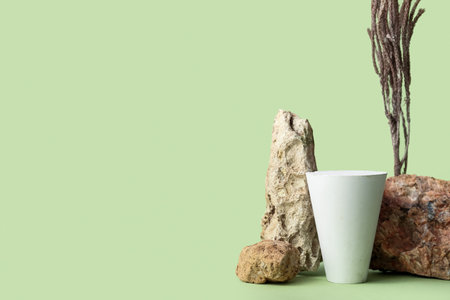 Decorative stone podiums with branches on green backgroundの写真素材