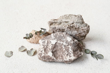 Decorative stone podiums with eucalyptus on white table