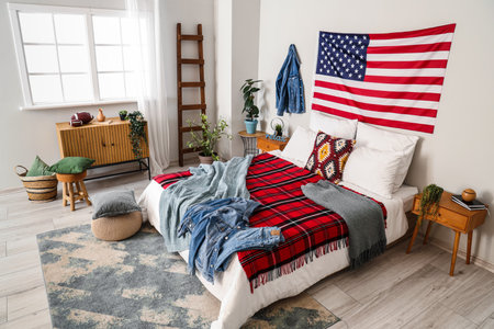 Interior of bedroom with USA flag and denim jacketsの写真素材