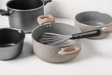 Set of cooking pots and whiskey on light background, closeupの写真素材