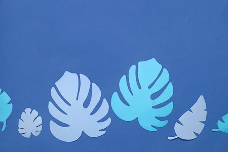 beautiful origami leaves on blue backgroundの写真素材
