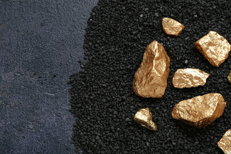 Golden nuggets and coal on dark backgroundの写真素材