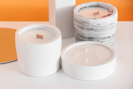 Holders with candles and decor on table in room, closeupの写真素材