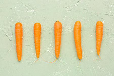 Many fresh carrots on green backgroundの写真素材