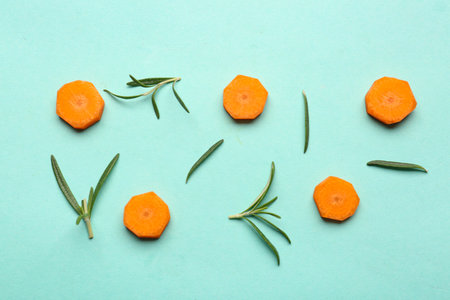 Slices of fresh carrots on turquoise backgroundの写真素材