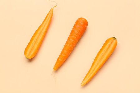 fresh carrot and slices on orange backgroundの写真素材