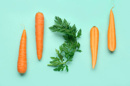Fresh carrots and slices on turquoise backgroundの写真素材