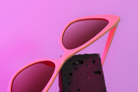 Stylish sunglasses on purple background, closeupの写真素材