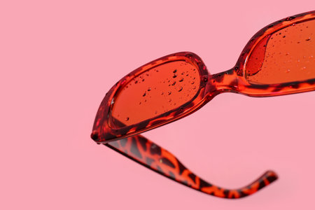 Stylish sunglasses on pink background, closeupの写真素材