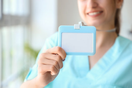 Female medical intern with badge at hospital, closeupの写真素材