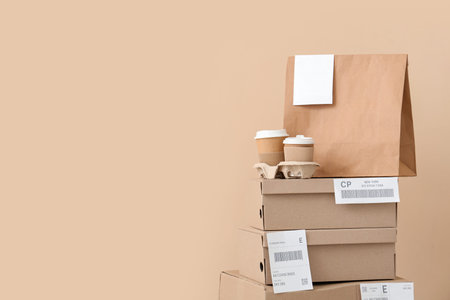 Parcels and containers with food on beige background