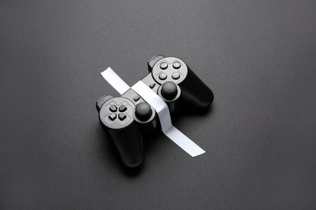 Game pad with adhesive tape on black background