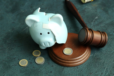 Broken patched piggy bank with judge gavel and money on grunge background. bankruptcy conceptの写真素材