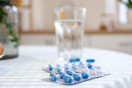 Folic Acid pills on dining table in kitchen, closeupの写真素材