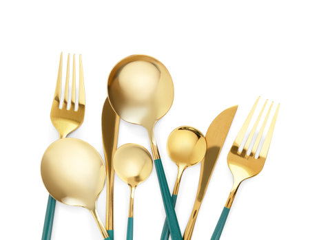 Golden set of cutlery with blue handles on white backgroundの写真素材