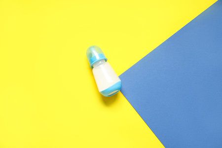 Bottle with milk for baby on color backgroundの写真素材