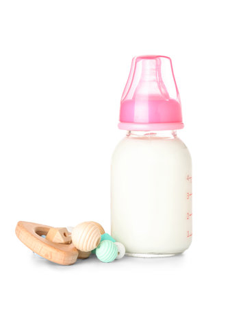 Bottle of milk for baby with rattle isolated on white backgroundの写真素材