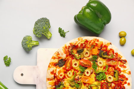 Board with vegetable pizza on gray backgroundの写真素材