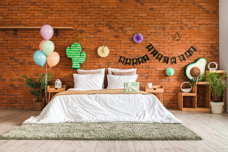 Interior of bedroom decorated for birthday with pinatas, balloons and garlandの写真素材