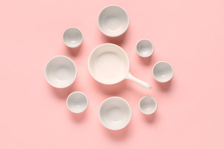 Composition with clean bowls and cups on pink backgroundの写真素材