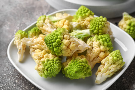 Plate with romanesco cabbage on gray grunge backgroundの写真素材