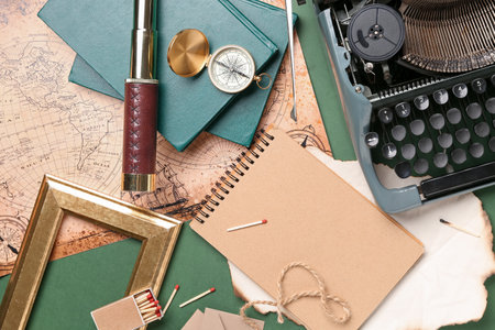 Composition with vintage typewriter, telescope, compass and map on green backgroundの写真素材