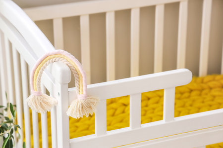 Baby crib with toy in light bedroom, closeupの写真素材