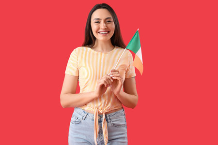 Young woman with flag of Italy on red backgroundの写真素材