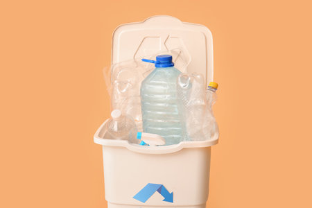 Container for garbage with plastic on beige background. Recycling conceptの写真素材