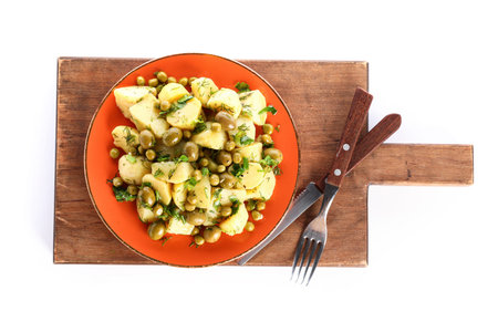 Plate of tasty Potato Salad with vegetables on white backgroundの写真素材